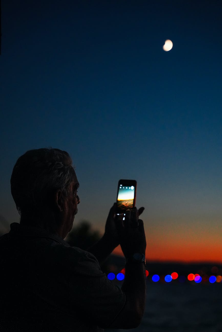 man taking picture at night